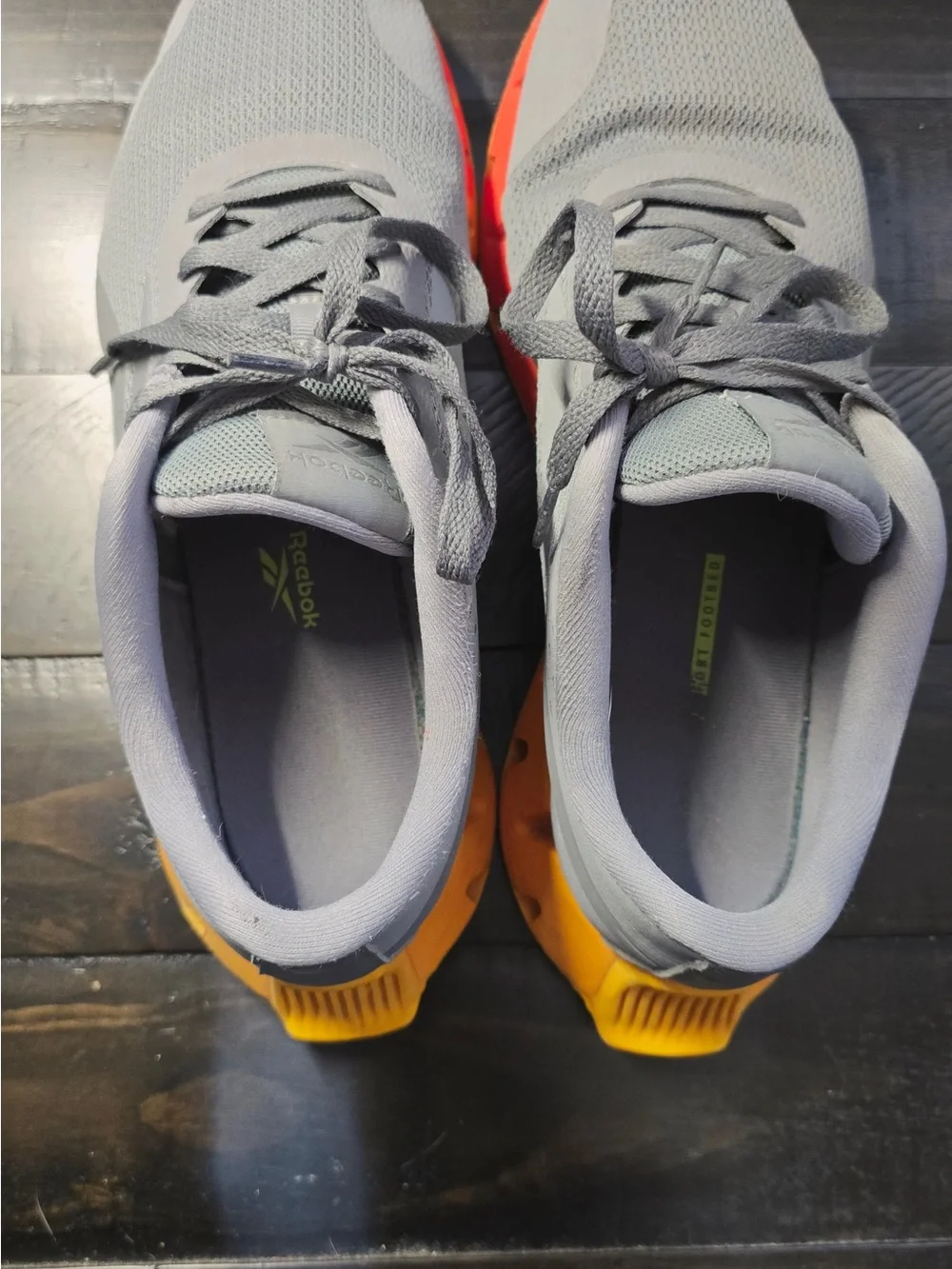 Reebok Grey Mesh Sneakers with Orange-Yellow Gradient Sole